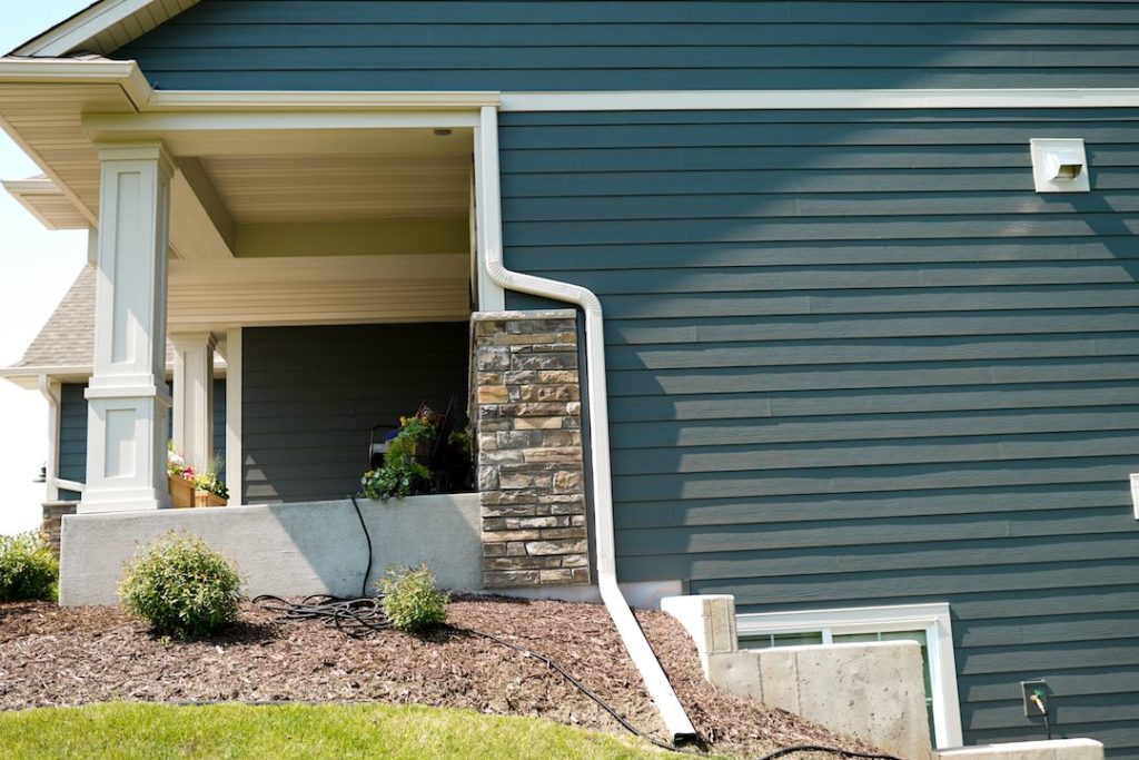 Efficiently designed gutters and downspouts being installed on a Medina, Ohio, home to protect against water damage and maintain foundation integrity