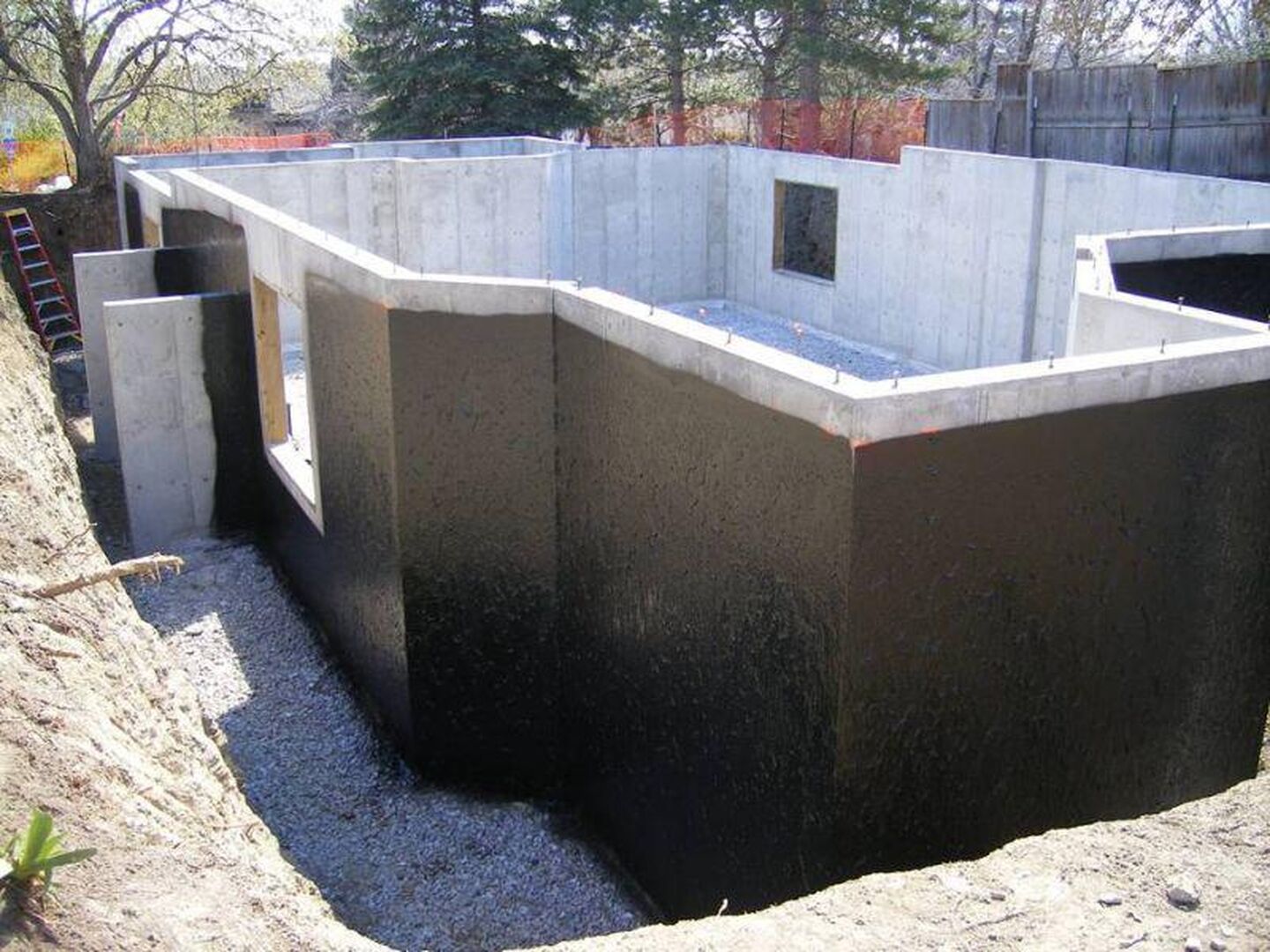 cross-section of a waterproofed basement in an Akron home, highlighting protection against moisture and water damage